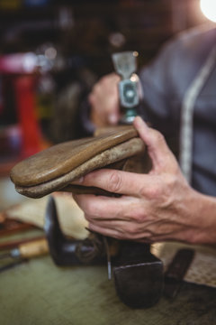 Close up of shoemaker working in workshop