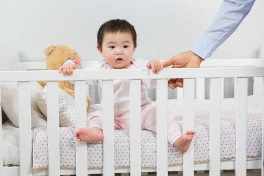 Cute baby looking up from crib