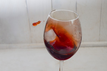 a splash of red fragrant wine in a glass