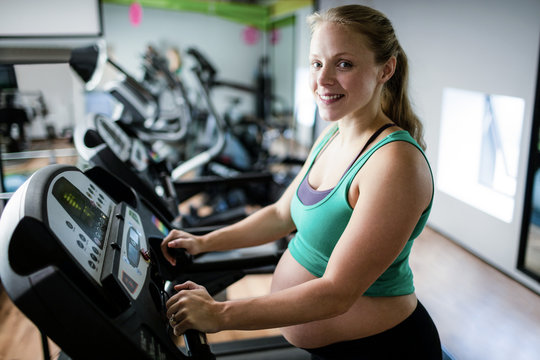 Pregnant woman exercising on treadmill