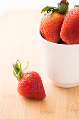 Ripe strawberry in white cup