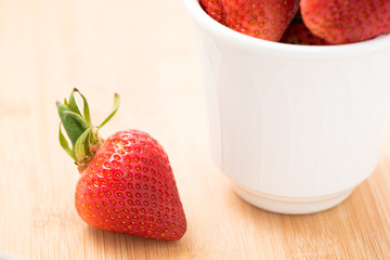 Ripe strawberry in white cup