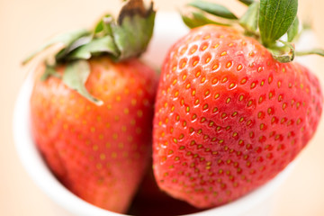 Ripe strawberry in white cup