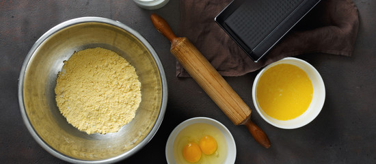 Set raw ingredients cooking corn bread dark background top view