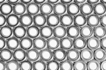 Background image of range of female screw. Many nuts close-up.