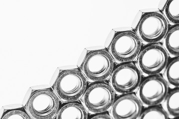 Background image of range of female screw. Many nuts close-up.