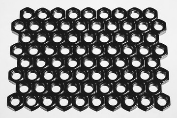 Background image of range of female screw. Many nuts close-up.