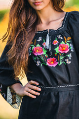 elegant black dress with embroidered flower pattern and white outline