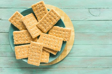 sugar crunchy cookies with sesame seeds on a wooden background