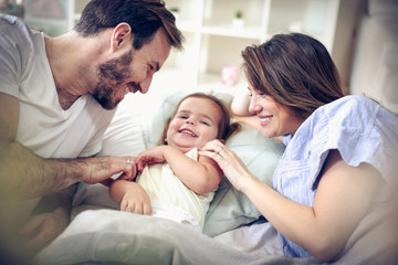 Obraz premium Parents playing with their daughter.