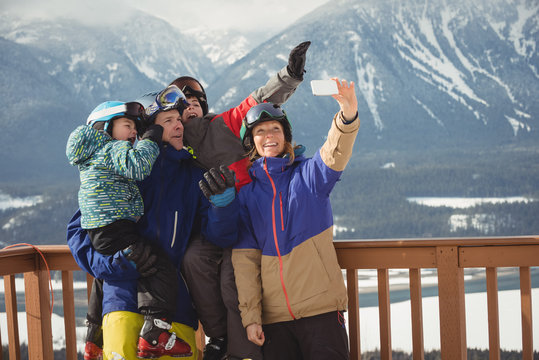Happy family taking selfie on mobile phone