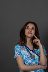 Fototapeta premium studio portrait of a young woman doctor on dark background