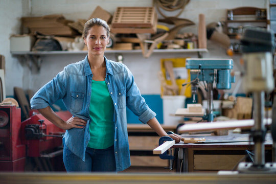 Portrait of female carpenter in workshop