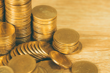 Columns of gold coins, piles of coins on working table, business banking and financial concept.