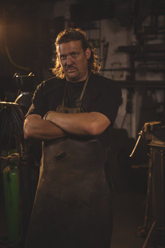 Portrait of blacksmith with arms crossed