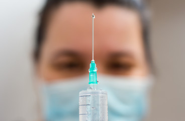 the doctor is preparing to make an injection © Irina