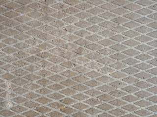 Concrete slab background with a notch in the form of rhombuses.