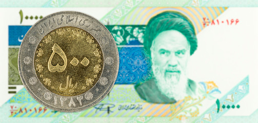 500 iranian rial coin against 10000 iranian rial note obverse