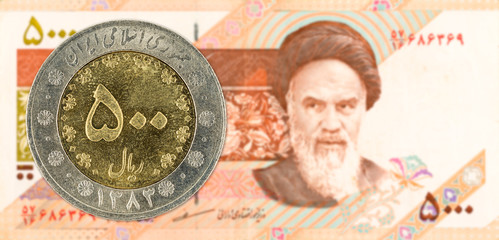 500 iranian rial coin against 5000 iranian rial note obverse