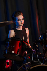 Obraz na płótnie Canvas Musician at drumset on dark background