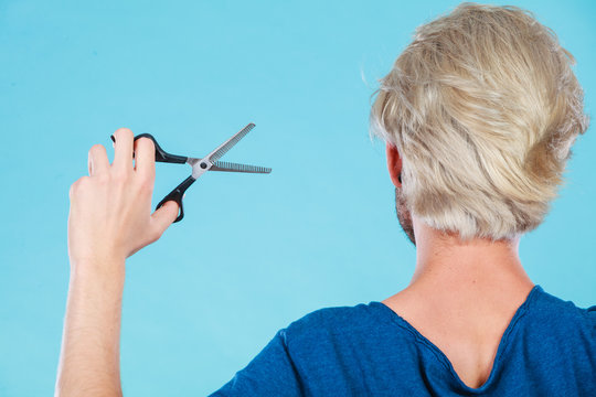 Man With Scissors Texturizing Or Thinning Shears