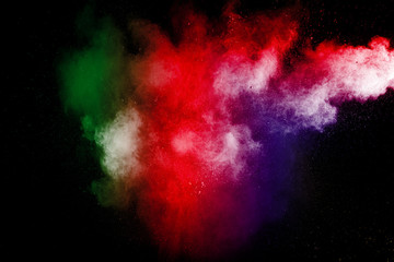 color powder explosion cloud isolated on black background. Freeze motion of color dust  particles splashing.