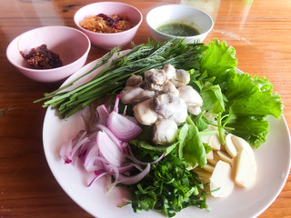 Oysters with spicy sauce and herbs, acacia, sliced onion, parsley, sliced garlic. This is Thai spicy seafood menu