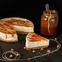 Caramel cheesecake and sauce jar, rustic dessert