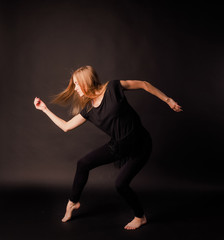 sporty girl dancing in black dress