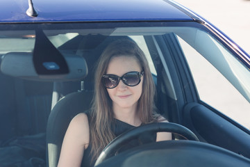 Obraz na płótnie Canvas Beautiful businesswoman in her car