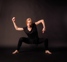 sporty girl dancing in black dress