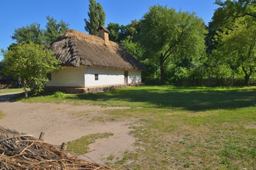 Fototapeta na wymiar White clay hut with a straw roof