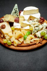 Cheese plate with Assorted cheeses Camembert, Brie, Parmesan blue cheese, goat