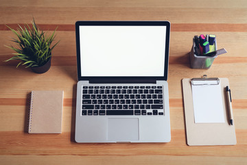 Laptop on table in office room background, for graphics display montage. Take your screen to put on advertising.