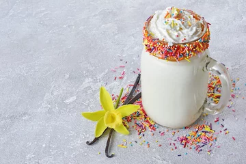 Papier Peint photo autocollant Milk-shake Crazy vanilla milk shake with whipped cream and colored sprinkles in glass jar