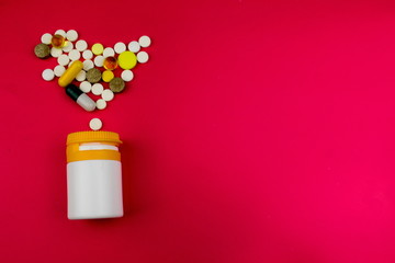 Medicine theme, white  tablets antibiotic pills. Red background. Pharmacy concept. Free space for text