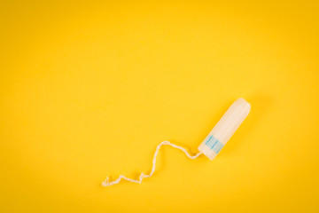 Sanitary pads and tampon on a yellow background. hygiene products