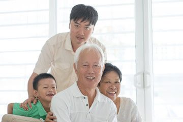 Portrait of Asian family at home