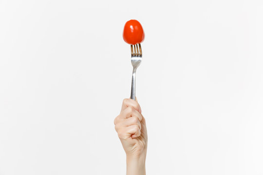 Close Up Female Holds In Hand Red Fresh Tomato On Fork Isolated On White Background. Proper Nutrition, Vegetarian Food, Healthy Lifestyle, Vegetable Vegan Concept. Advertising Area With Copy Space