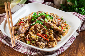 Fried rice with chicken and vegetables served on a plate