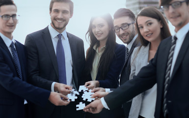 Group of business people assembling jigsaw puzzle, team support 