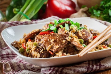 Fried rice with chicken and vegetables served on a plate