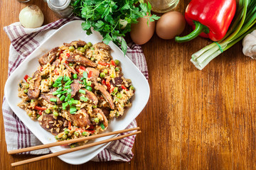 Fried rice with chicken and vegetables served on a plate