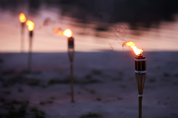Traditional wooden torch flame at night