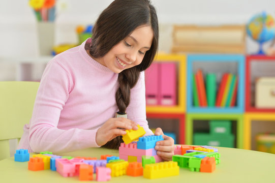 Little girl with colorful plastic blocks