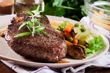 Beef steak served with baked potatoes