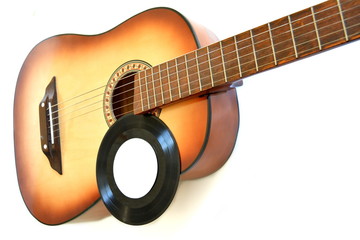 Obraz premium acoustic wooden guitar and Vintage vinil record with empty clear label for your text on white background