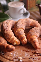 Sweet bagels on a wooden Board with a Cup of coffee