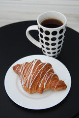 Coffee and Croissants White Chocolate Breakfast morning Isoalted on Black Table.