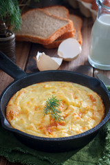 Potato casserole in a portioned cast-iron frying pan, selective focus